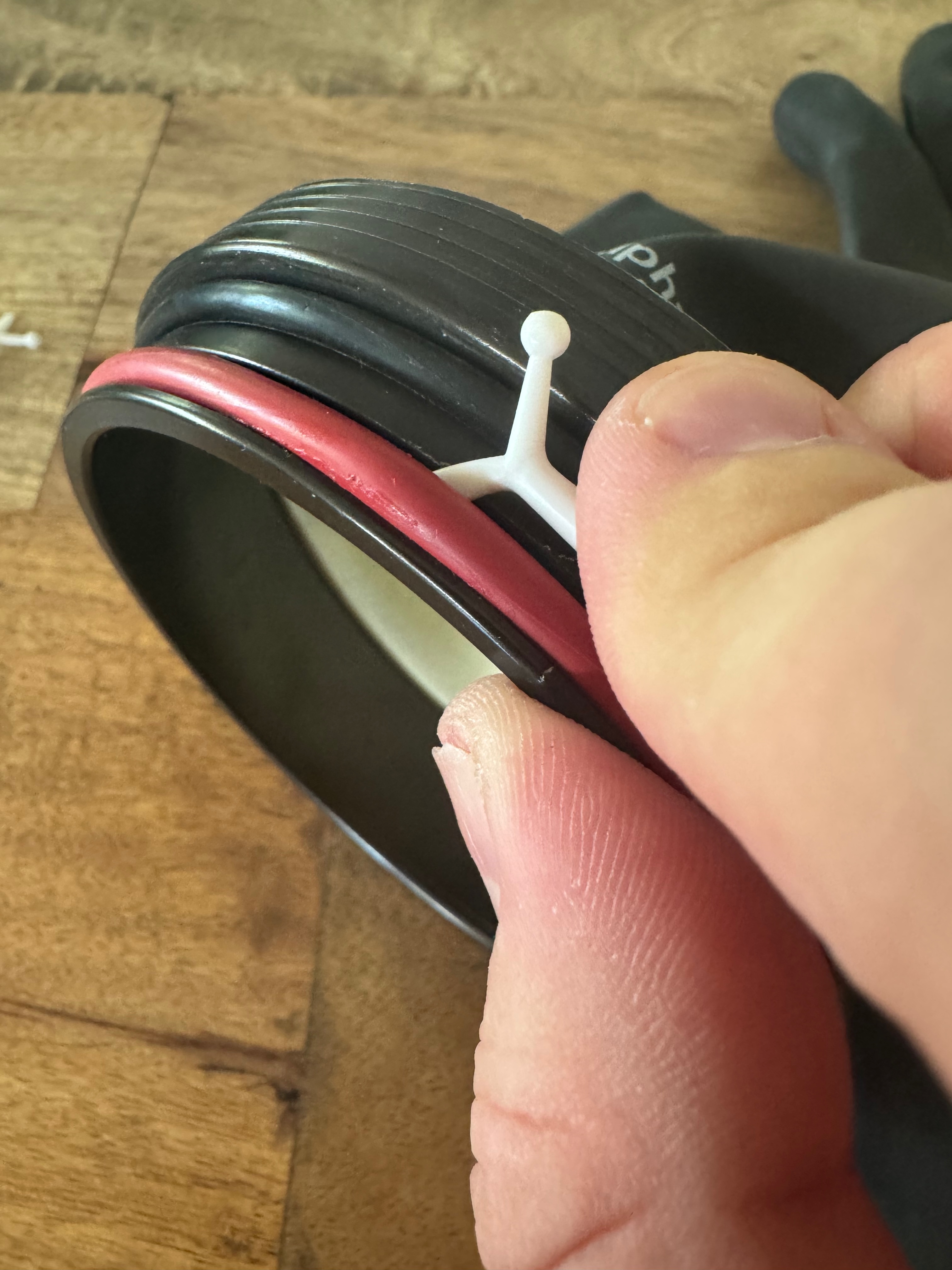 Plastic pick lifting the red o-ring out of its groove on the Kubi sleeve ring