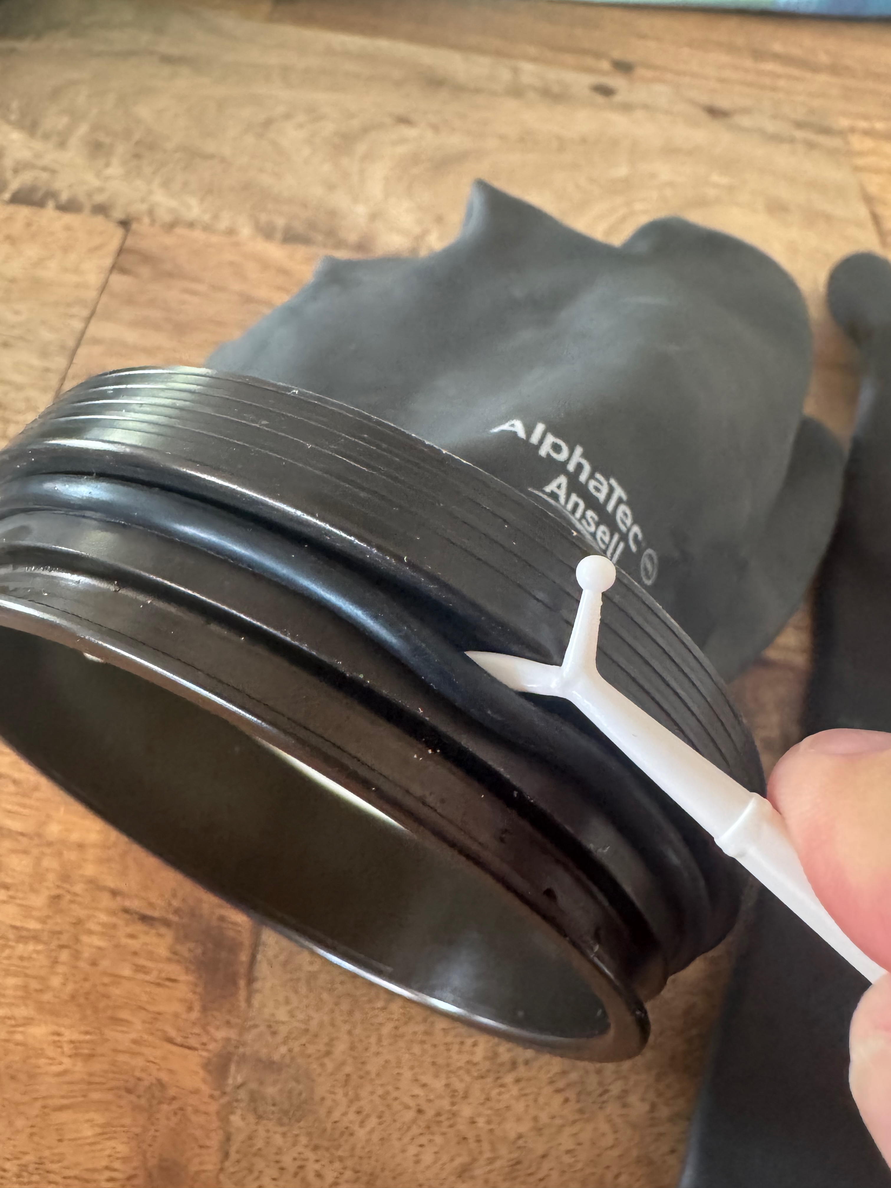 Plastic pick removing the black o-ring that retains the protective outer ring on the Kubi assembly