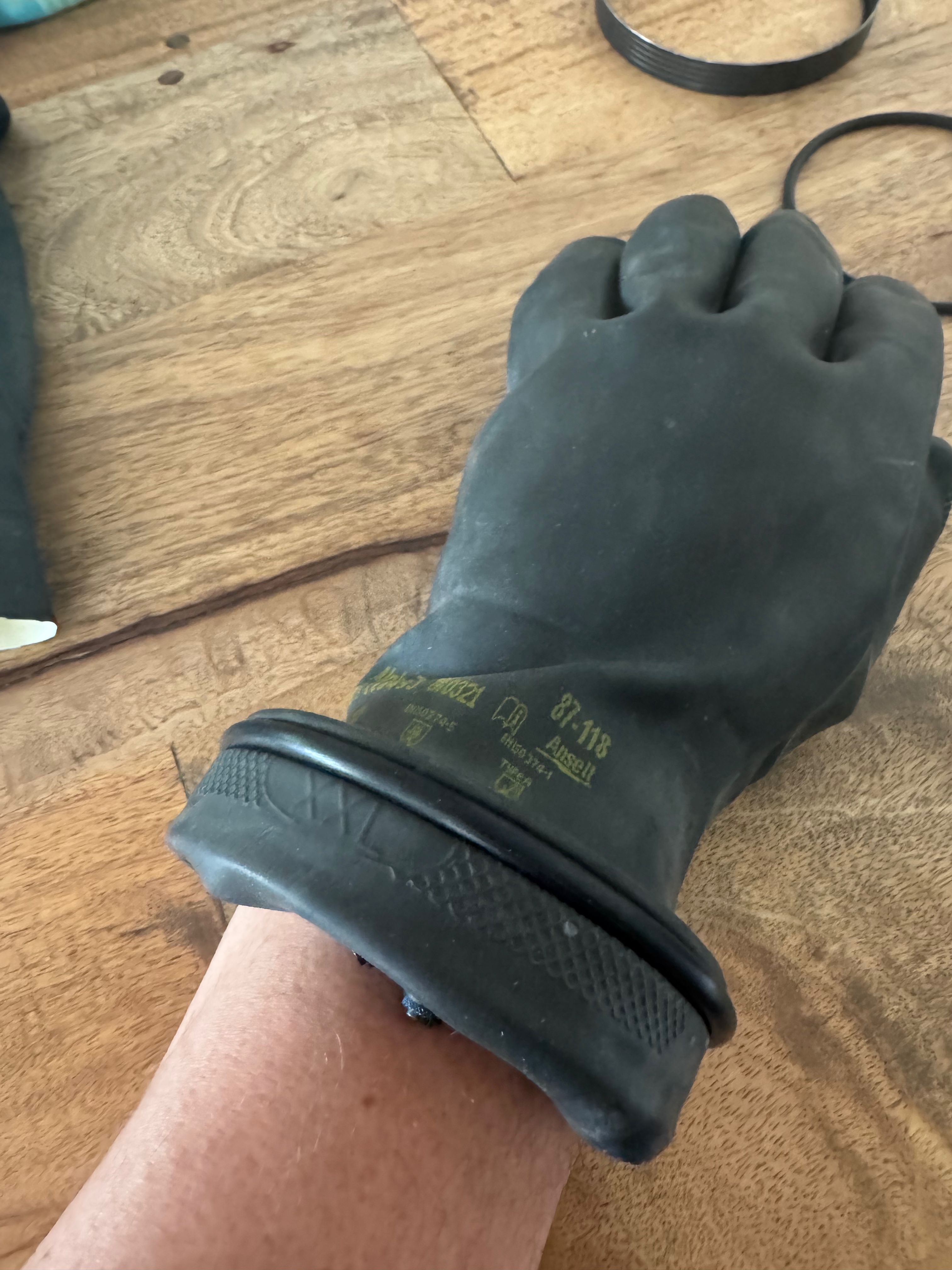 Assembled Kubi glove ring on a wrist, checking the fit before trimming