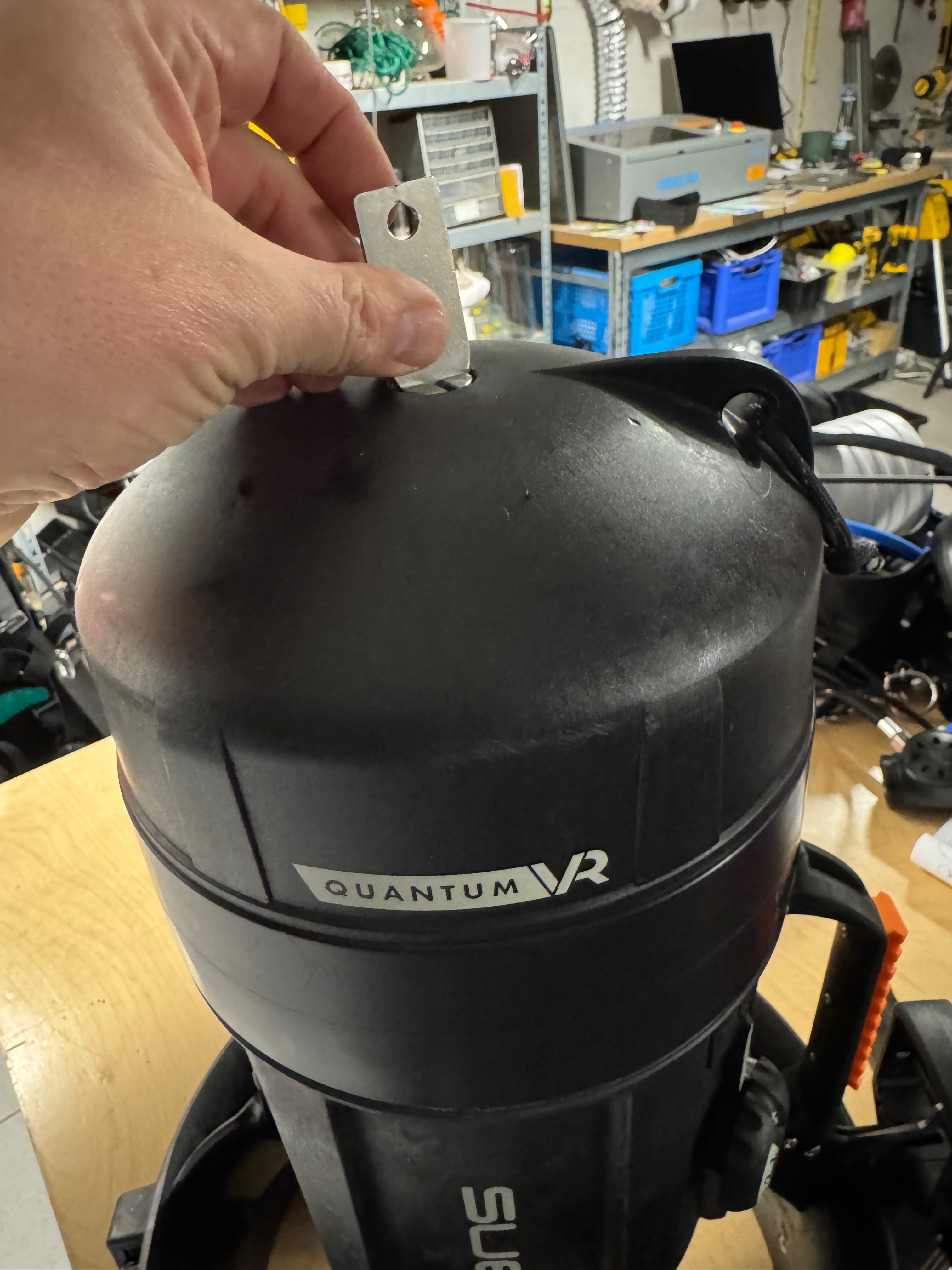 Using the provided tab tool to tighten the nosecone retaining bolt on the SUEX Quantum VR